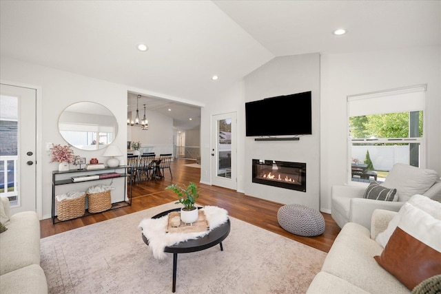 5916 S Division St, Spokane, WA 99224 - living room with a chandelier, vaulted ceiling, wood finished floors, a glass covered fireplace, and recessed lighting