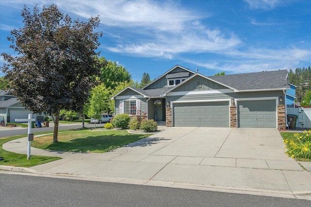 5916 S Division St, Spokane, WA 99224 - craftsman inspired home with stone siding, board and batten siding, a garage, a front yard, and driveway