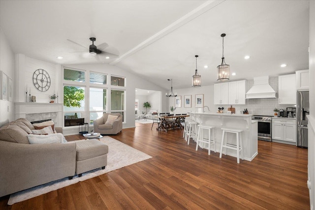 5916 S Division St, Spokane, WA 99224 - living area with a ceiling fan, dark wood-type flooring, lofted ceiling, a fireplace, and a chandelier