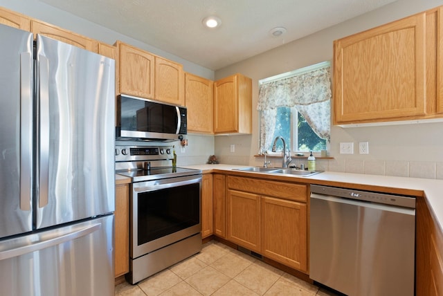 17813 N Lidgerwood St, Colbert, WA 99005 - kitchen with appliances with stainless steel finishes, light countertops, light tile patterned flooring, light brown cabinetry, and recessed lighting
