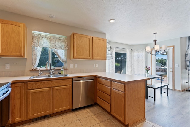 17813 N Lidgerwood St, Colbert, WA 99005 - kitchen featuring dishwasher, a peninsula, a chandelier, plenty of natural light, and a textured ceiling