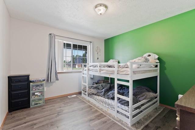 17813 N Lidgerwood St, Colbert, WA 99005 - bedroom with wood finished floors and a textured ceiling