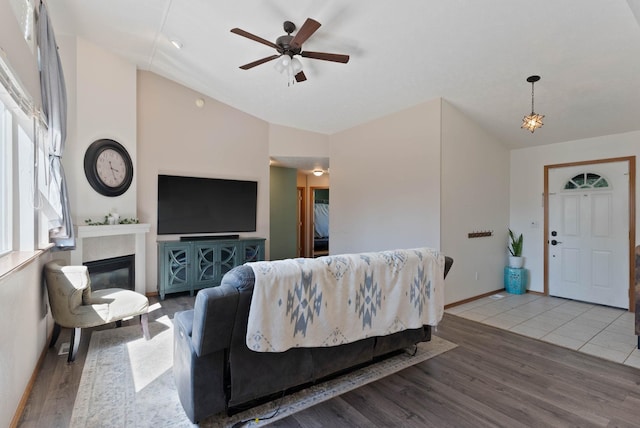 17813 N Lidgerwood St, Colbert, WA 99005 - living area with wood finished floors, vaulted ceiling, ceiling fan, and a glass covered fireplace