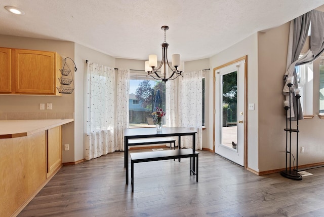 17813 N Lidgerwood St, Colbert, WA 99005 - dining room with a chandelier, dark wood-style flooring, plenty of natural light, and a textured ceiling