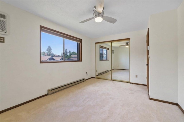 417 Clay St Unit A, Cheney, WA 99004 - unfurnished bedroom with a baseboard heating unit, carpet, a closet, and ceiling fan