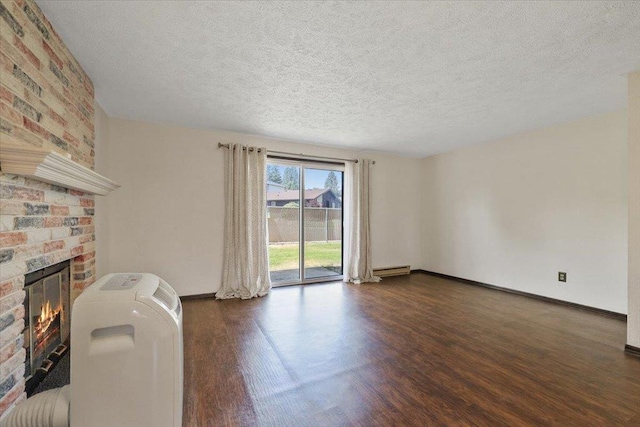 417 Clay St Unit A, Cheney, WA 99004 - living area featuring a brick fireplace, dark wood-type flooring, a textured ceiling, and baseboard heating