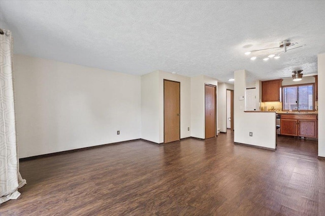 417 Clay St Unit A, Cheney, WA 99004 - unfurnished living room with dark wood-style flooring and a textured ceiling