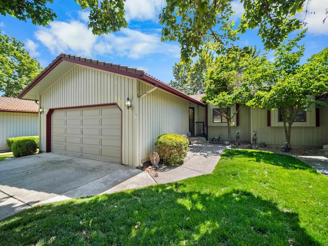 3808 S Alder Dr, Spokane, WA 99223 - view of front of home with a tile roof, a front lawn, an attached garage, and driveway