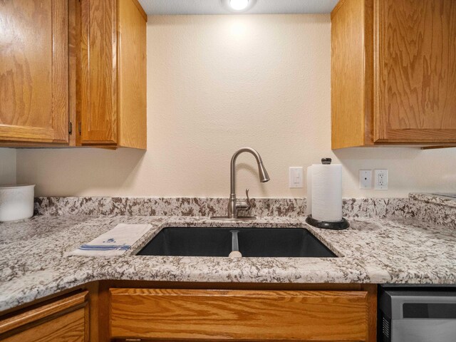 3808 S Alder Dr, Spokane, WA 99223 - kitchen with light stone countertops and brown cabinets