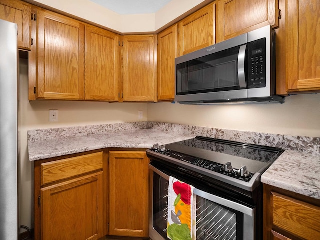 3808 S Alder Dr, Spokane, WA 99223 - kitchen with stainless steel appliances and brown cabinetry