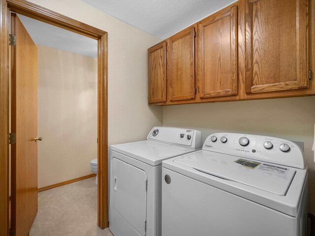 3808 S Alder Dr, Spokane, WA 99223 - laundry area with washer and clothes dryer, light colored carpet, and a textured ceiling