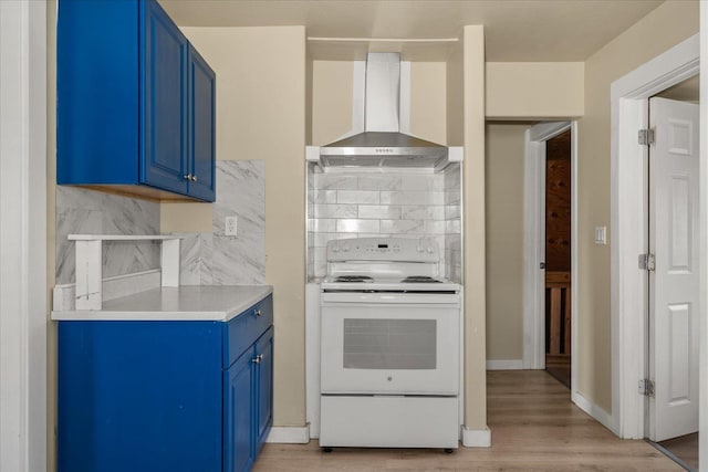 2323 E Rich Ave, Spokane, WA 99207 - kitchen with white range with electric cooktop, blue cabinetry, wall chimney exhaust hood, and decorative backsplash
