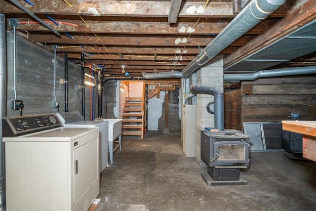 2323 E Rich Ave, Spokane, WA 99207 - unfinished below grade area featuring washer and clothes dryer and a wood stove