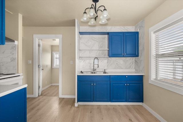 2323 E Rich Ave, Spokane, WA 99207 - bar featuring decorative backsplash, a chandelier, light wood-style flooring, and hanging light fixtures