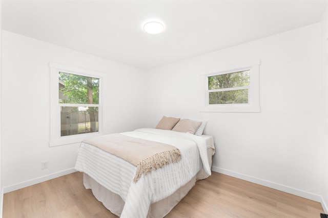 1227 E Providence Ave, Spokane, WA 99207 - bedroom with baseboards and light wood-style floors