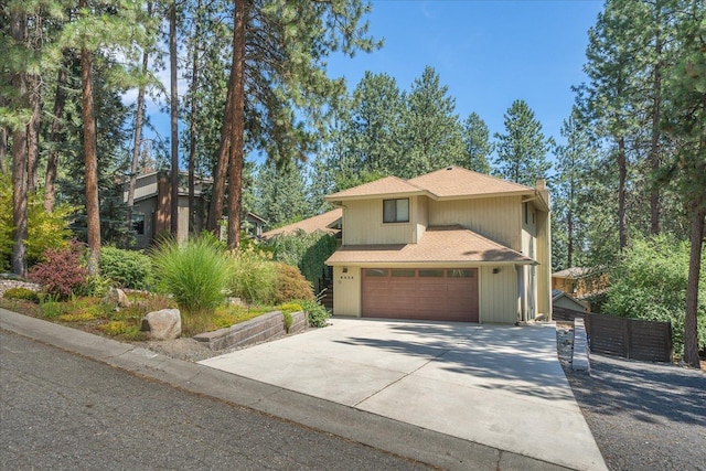 8024 E Elde Dr, Spokane, WA 99212 - view of front of property with driveway, roof with shingles, a garage, and a chimney
