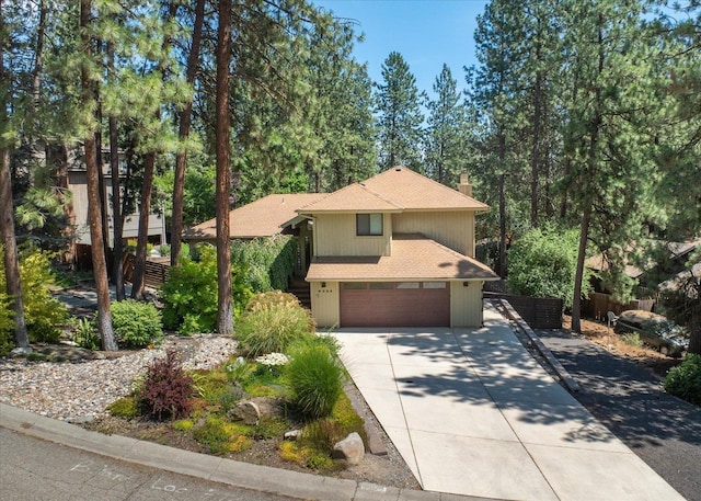 8024 E Elde Dr, Spokane, WA 99212 - view of front facade featuring an attached garage, a chimney, roof with shingles, and concrete driveway