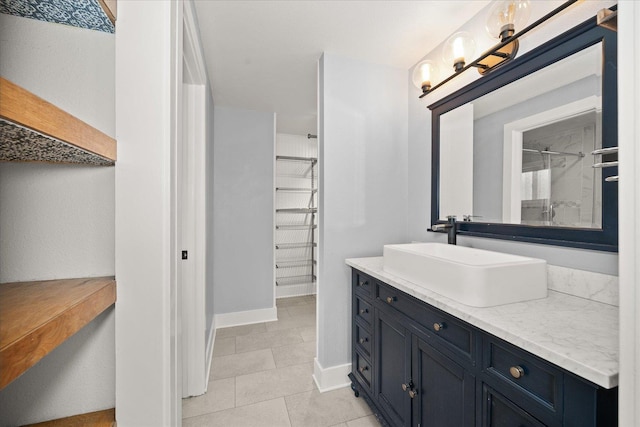 8024 E Elde Dr, Spokane, WA 99212 - bathroom featuring a walk in closet, vanity, and tile patterned floors