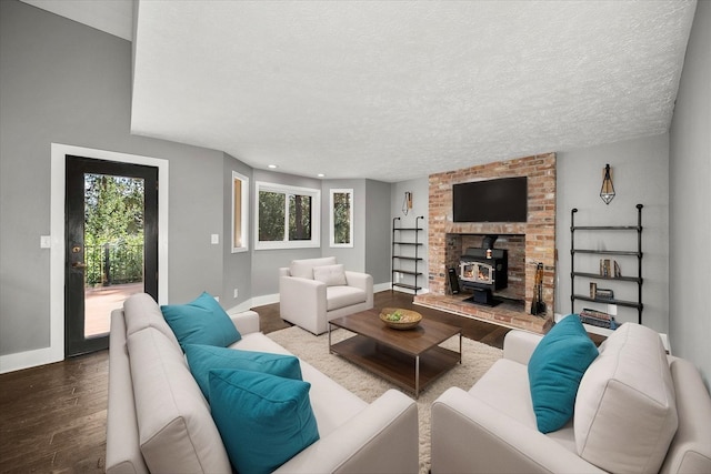 8024 E Elde Dr, Spokane, WA 99212 - living room featuring a wood stove, wood finished floors, a textured ceiling, and recessed lighting