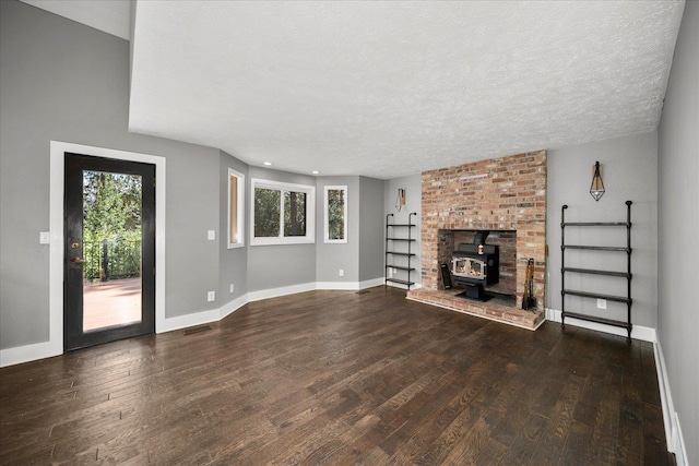 8024 E Elde Dr, Spokane, WA 99212 - unfurnished living room with wood finished floors, a wood stove, and a textured ceiling
