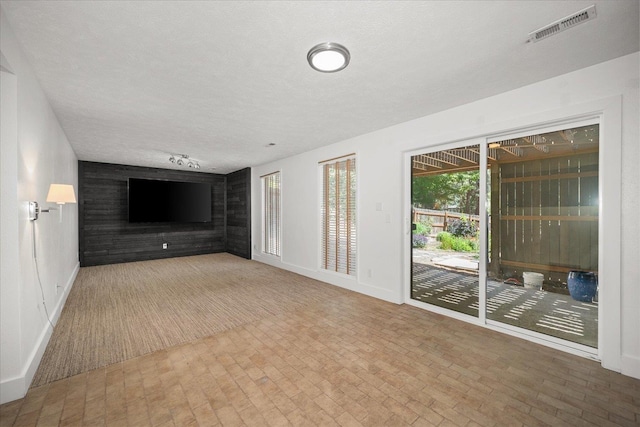 8024 E Elde Dr, Spokane, WA 99212 - unfurnished living room with baseboards and a textured ceiling