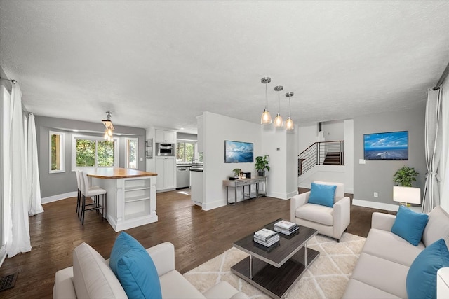 8024 E Elde Dr, Spokane, WA 99212 - living room featuring stairway, wood finished floors, a chandelier, and a textured ceiling