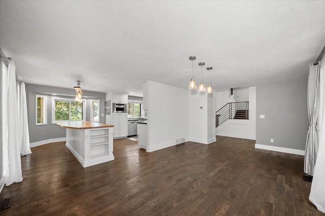 8024 E Elde Dr, Spokane, WA 99212 - unfurnished living room with dark wood finished floors and stairway