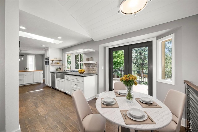 8024 E Elde Dr, Spokane, WA 99212 - dining area featuring plenty of natural light, dark wood-type flooring, vaulted ceiling, a skylight, and french doors