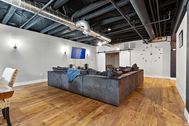 315 W Riverside Ave Unit 101, Spokane, WA 99201 - living room featuring wood finished floors and a barn door