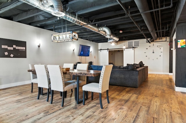 315 W Riverside Ave Unit 101, Spokane, WA 99201 - dining area with a barn door and wood finished floors
