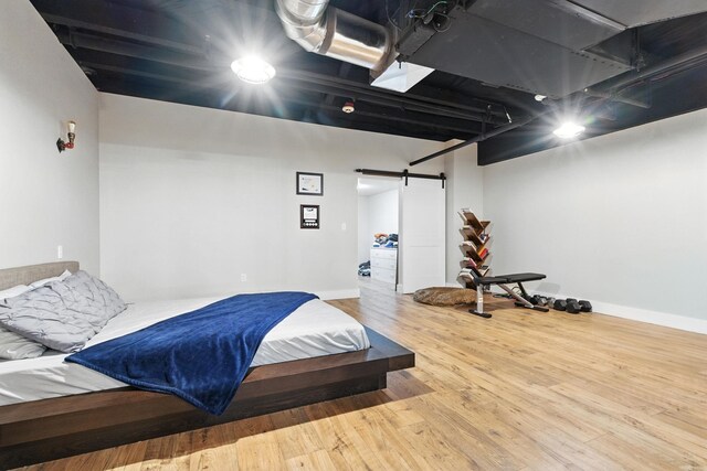 315 W Riverside Ave Unit 101, Spokane, WA 99201 - bedroom with a barn door and wood finished floors