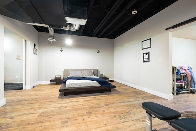 315 W Riverside Ave Unit 101, Spokane, WA 99201 - bedroom with a barn door and wood finished floors