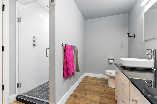315 W Riverside Ave Unit 101, Spokane, WA 99201 - full bath with vanity, wood finished floors, and a shower stall