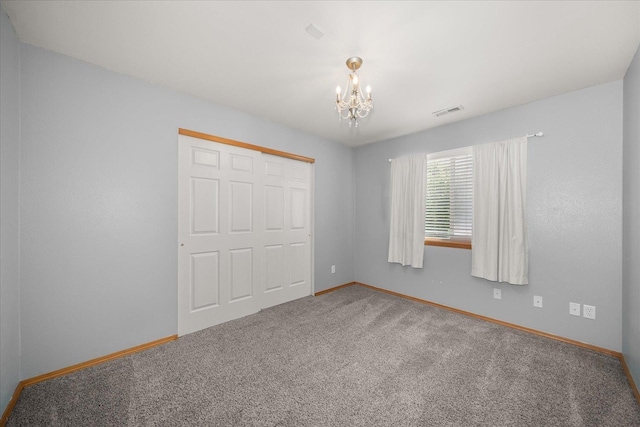 10002 W Richland Rd, Cheney, WA 99004 - unfurnished bedroom featuring a chandelier, carpet, and a closet