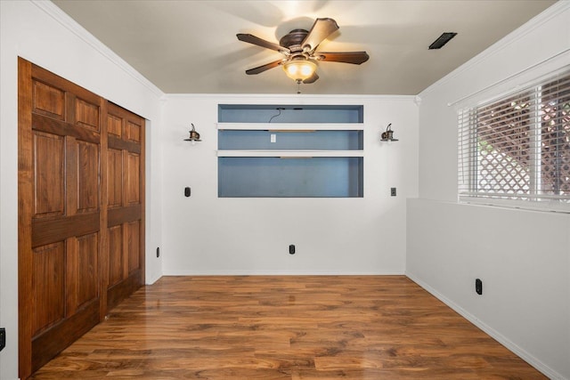 10002 W Richland Rd, Cheney, WA 99004 - unfurnished bedroom featuring wood finished floors, ornamental molding, and ceiling fan