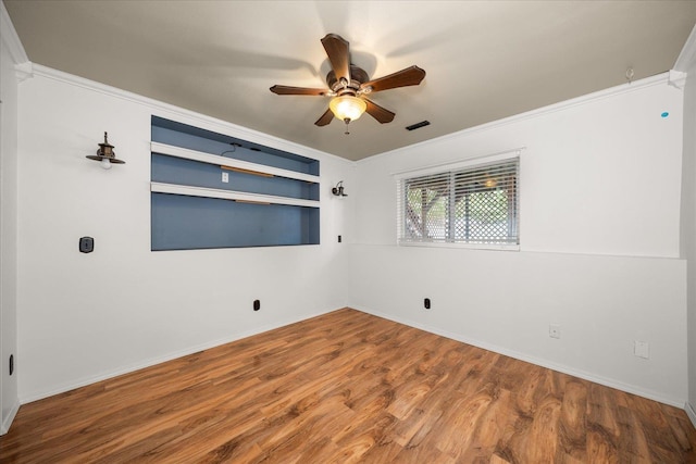 10002 W Richland Rd, Cheney, WA 99004 - spare room featuring crown molding, ceiling fan, wood finished floors, and built in shelves
