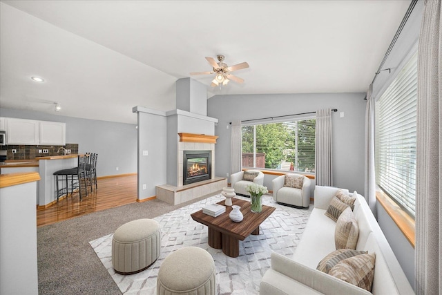 10002 W Richland Rd, Cheney, WA 99004 - living area featuring light colored carpet, lofted ceiling, a tile fireplace, and ceiling fan