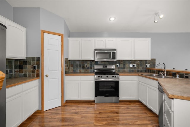 10002 W Richland Rd, Cheney, WA 99004 - kitchen featuring stainless steel appliances, white cabinets, a peninsula, backsplash, and recessed lighting