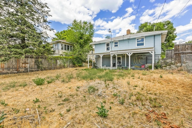 3608 E Fairview Ave, Spokane, WA 99217 - back of property with a fenced backyard and a chimney