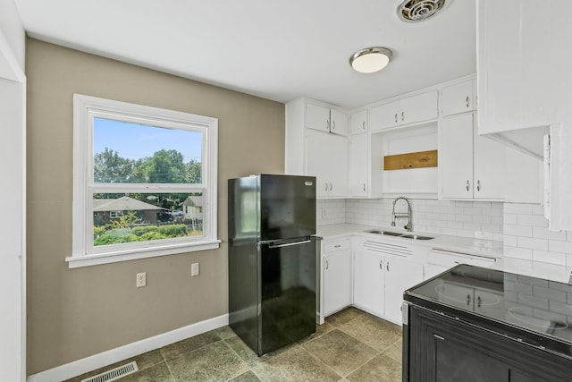 3608 E Fairview Ave, Spokane, WA 99217 - kitchen featuring freestanding refrigerator, electric range, backsplash, white cabinetry, and light countertops