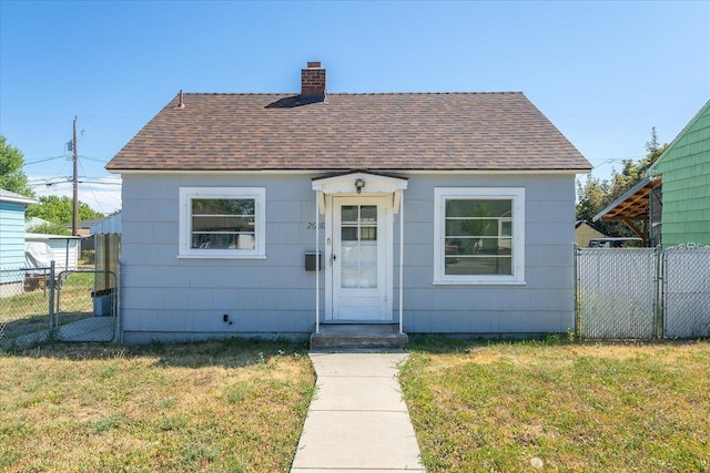 2608 E Heroy Ave, Spokane, WA 99207 - view of front facade featuring a shingled roof, a gate, and a chimney