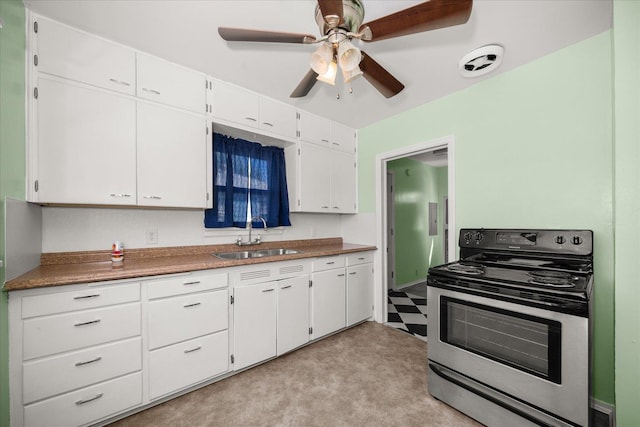2608 E Heroy Ave, Spokane, WA 99207 - kitchen featuring stainless steel electric range, white cabinetry, light colored carpet, a ceiling fan, and dark countertops