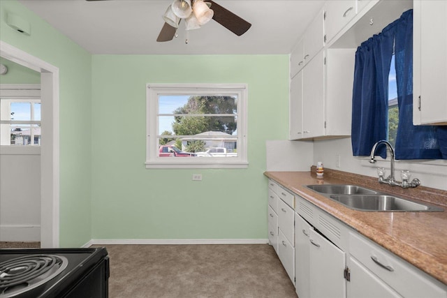 2608 E Heroy Ave, Spokane, WA 99207 - kitchen with plenty of natural light, ceiling fan, white cabinets, and light carpet