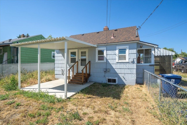 2608 E Heroy Ave, Spokane, WA 99207 - rear view of house featuring entry steps, roof with shingles, a chimney, a patio area, and crawl space