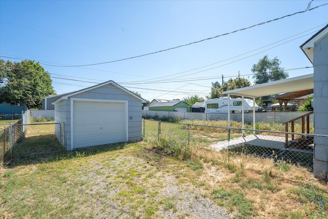 2608 E Heroy Ave, Spokane, WA 99207 - view of yard with driveway, a detached garage, and an outbuilding