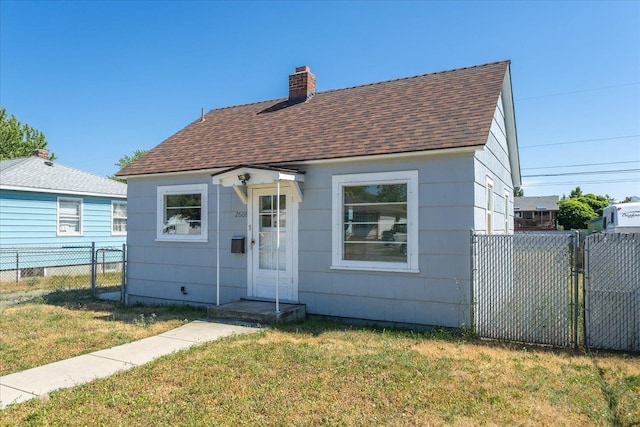 2608 E Heroy Ave, Spokane, WA 99207 - view of front of home with roof with shingles, a gate, and a chimney