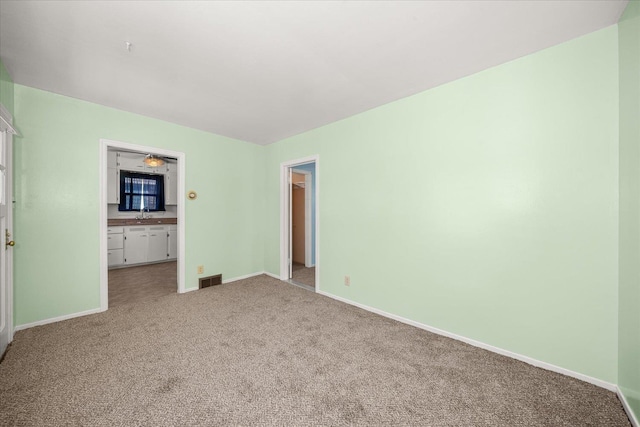 2608 E Heroy Ave, Spokane, WA 99207 - unfurnished bedroom featuring light colored carpet and connected bathroom