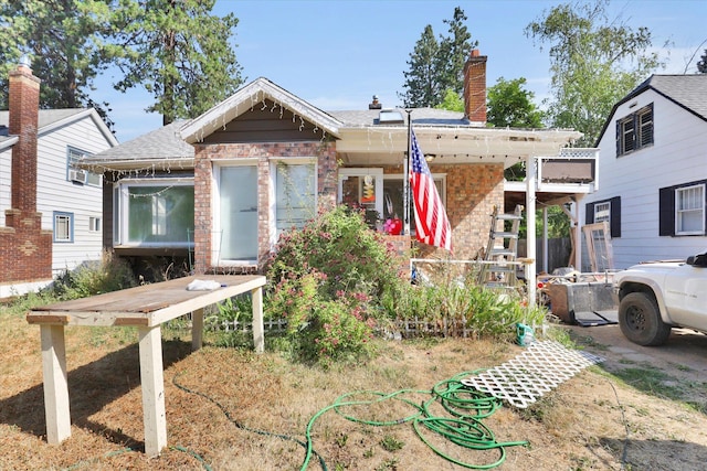 452 W 26th Ave, Spokane, WA 99203 - view of front of home featuring brick siding, a shingled roof, and a chimney