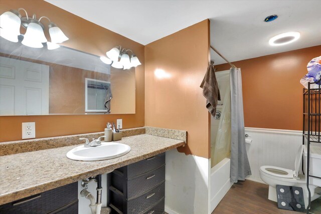452 W 26th Ave, Spokane, WA 99203 - full bathroom featuring vanity, wood finished floors, shower / bath combo, and a wainscoted wall