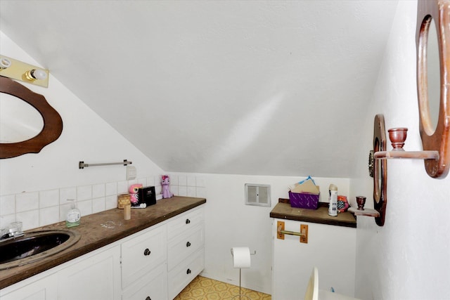 452 W 26th Ave, Spokane, WA 99203 - bathroom featuring decorative backsplash, lofted ceiling, and vanity